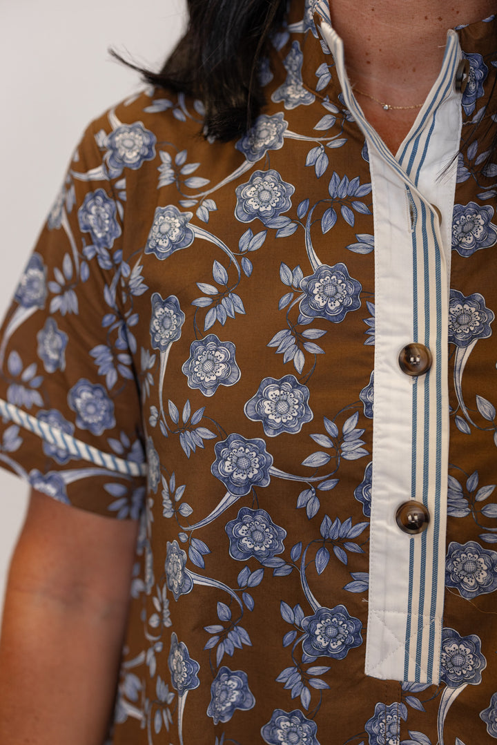 Women's brown dress with blue floral print and striped trim by Entro showing button detailing