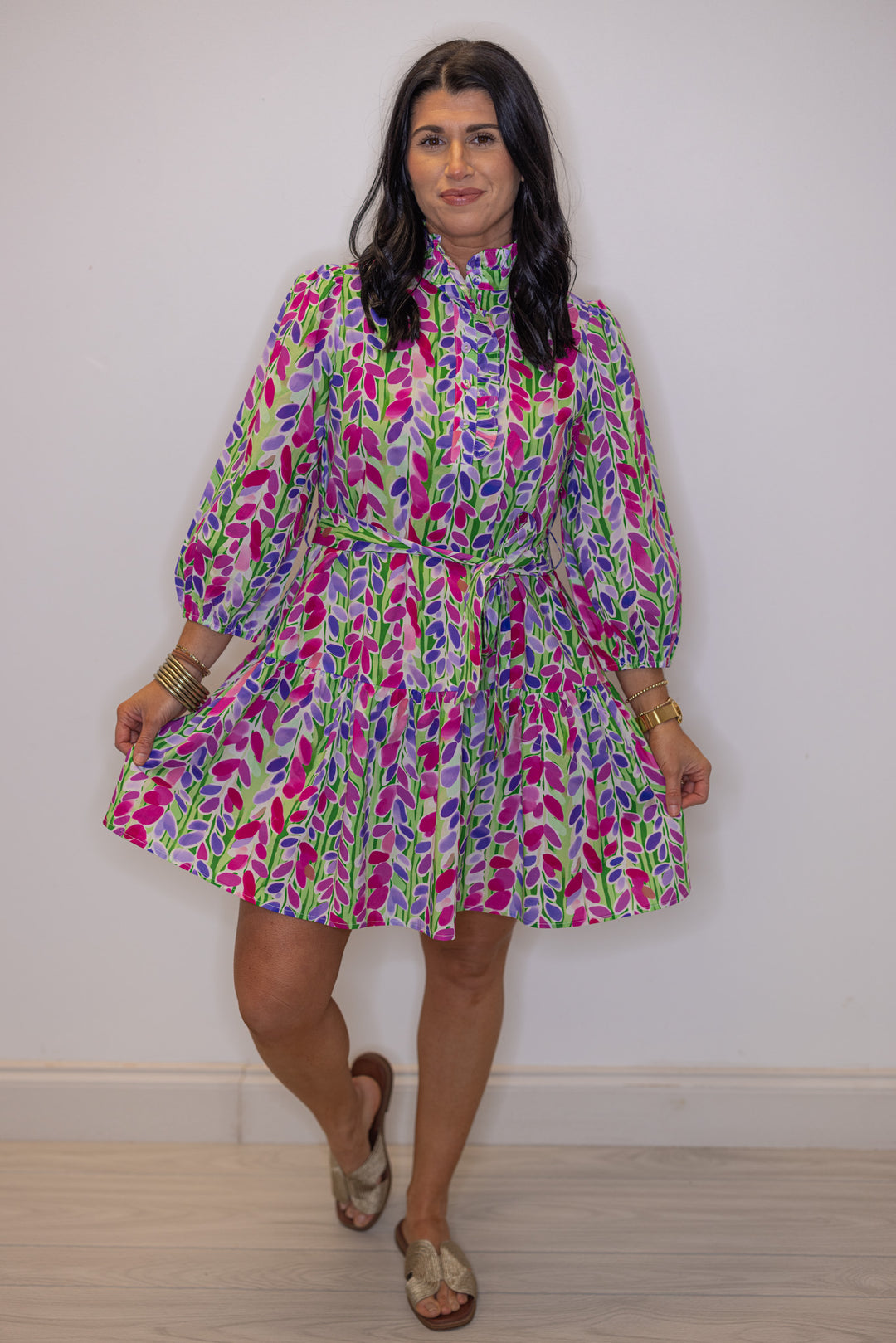 Women's green poplin dress with multicolor floral print by Jodifl showing tiered bottom hem