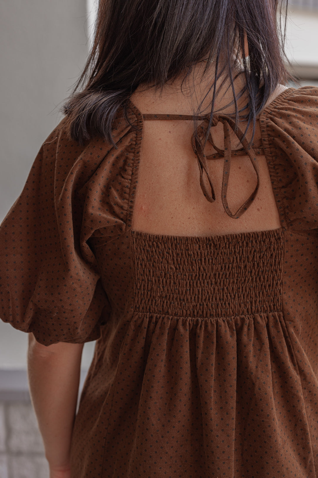 Women's brown pleated corduroy dress with black polkadots by Wishlist showing up close back view