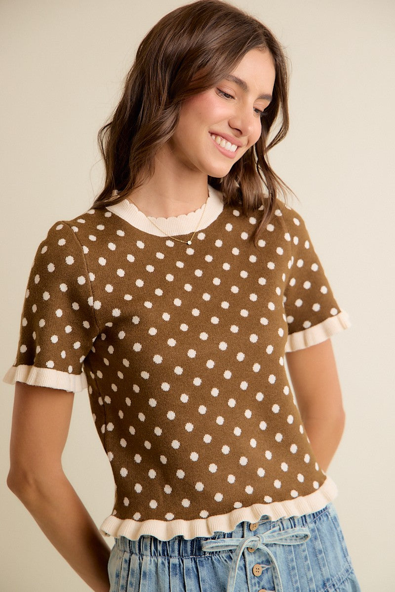 Brown and cream knit top with ruffle trim and a crew neckline