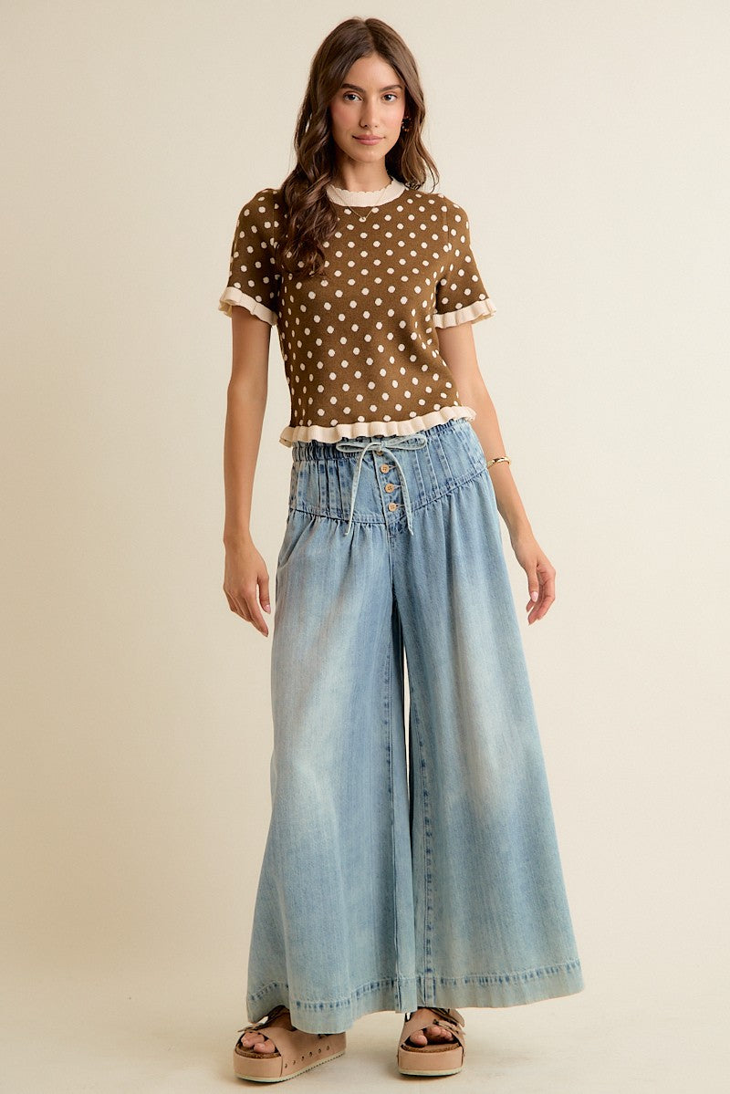 Brown and cream knit top with ruffle trim in a cropped style