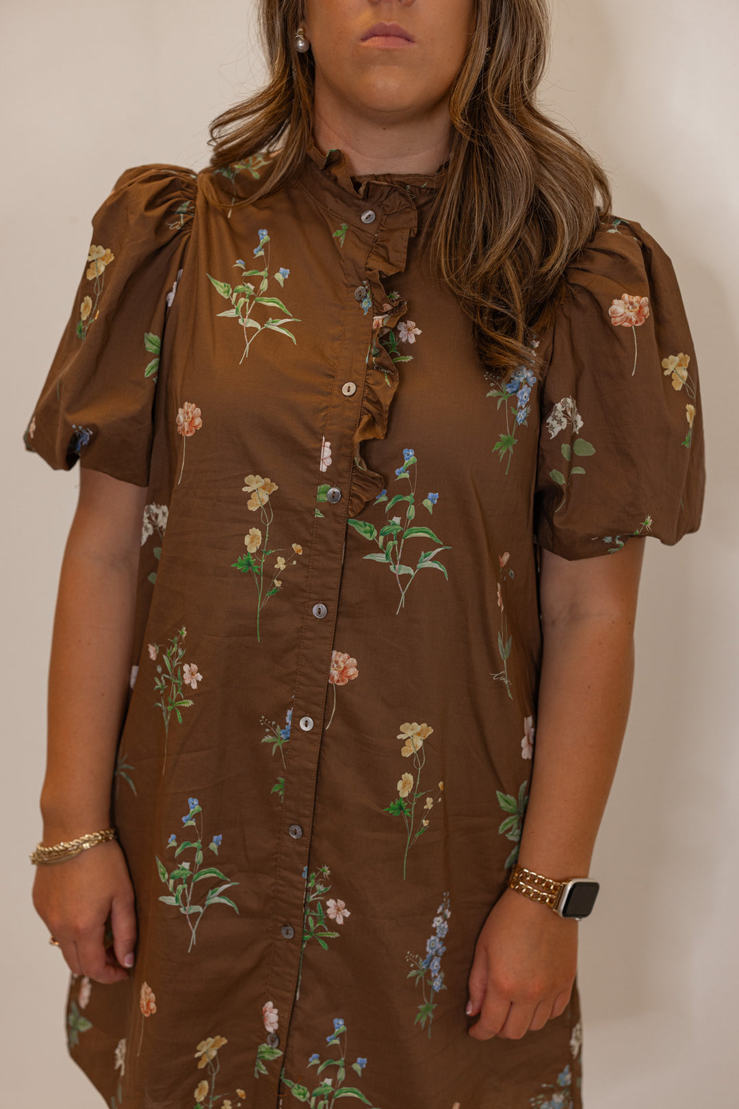 Women's brown multicolor floral print button front poplin dress by Entro showing ruffle detail and button front closure