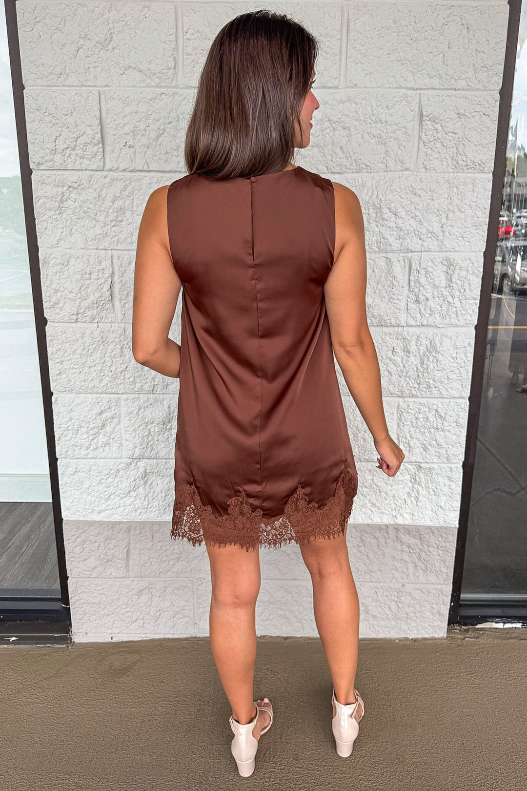 solid chocolate brown sleeveless satin shift dress with lace fringe hemline and back keyhole opening