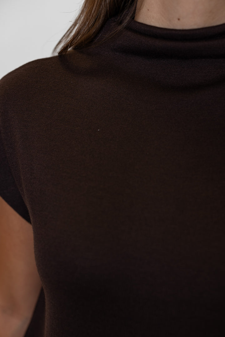 Women's brown knit cropped top by Entro, showing up close view of mock neckline
