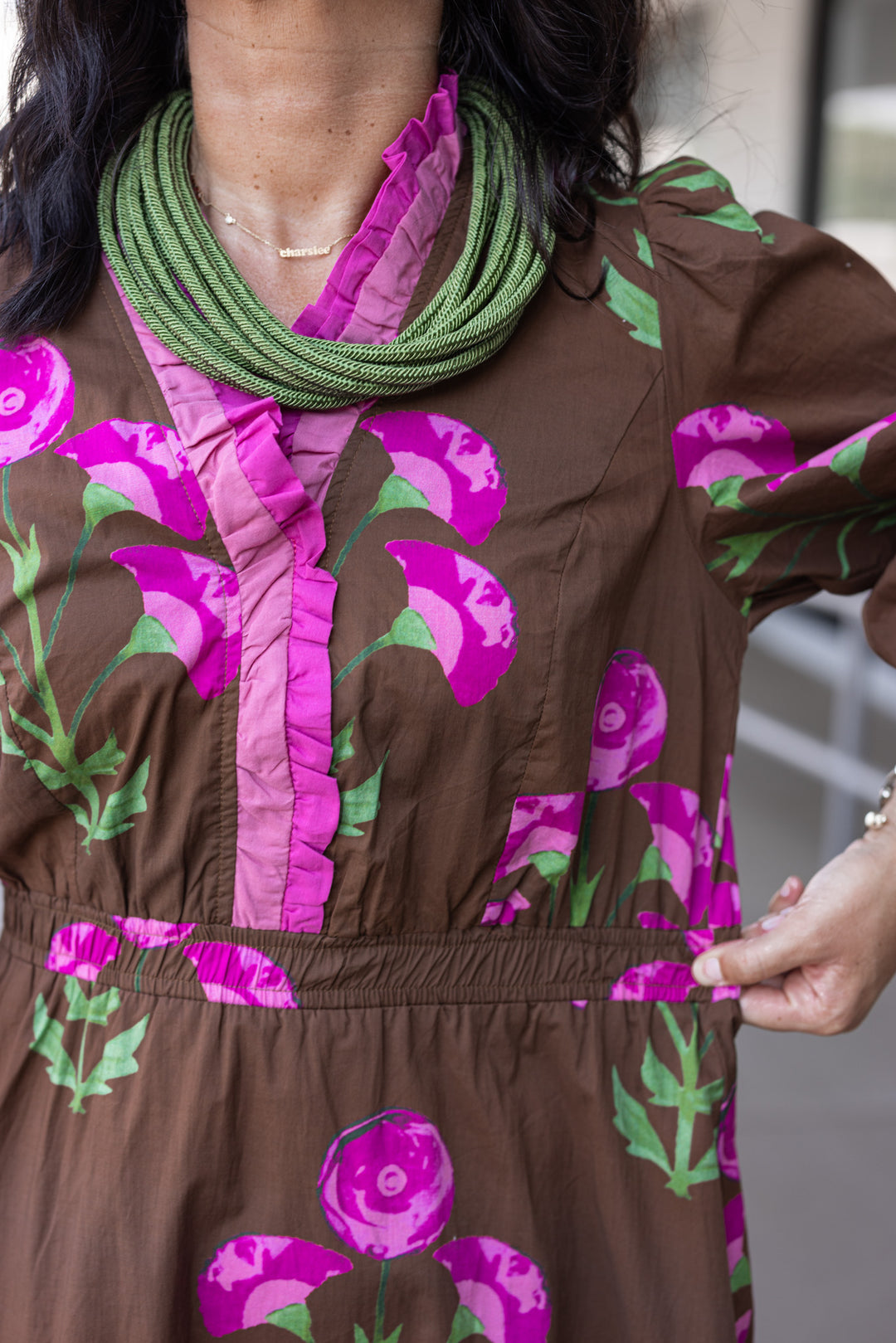 Women's brown midi dress with pink and green florals and pink ruffle trim by Umgee showing elastic waistband