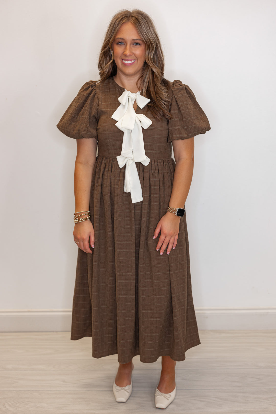 Women's brown check-textured monochrome midi dress with cream bows by In February showing full front view