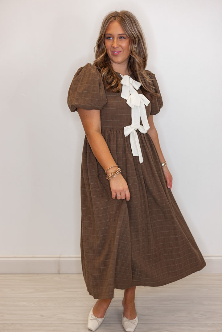 Women's brown check-textured monochrome midi dress with cream bows by In February showing flowy skirt