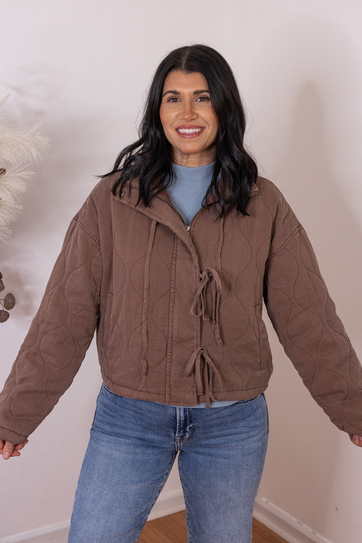 Women's washed brown quilted puffer jacket with bow ties down the front by Blu Pepper