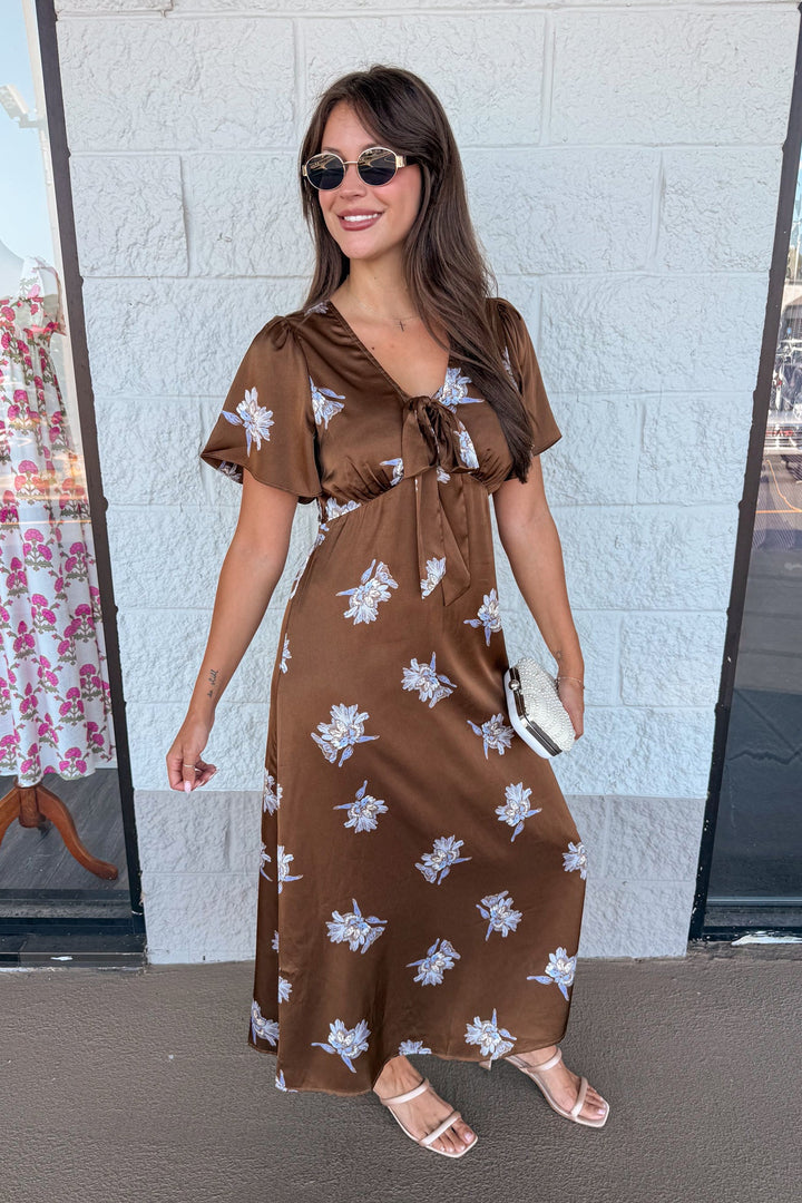 dark brown satin midi dress with light blue floral print and tie chest detail