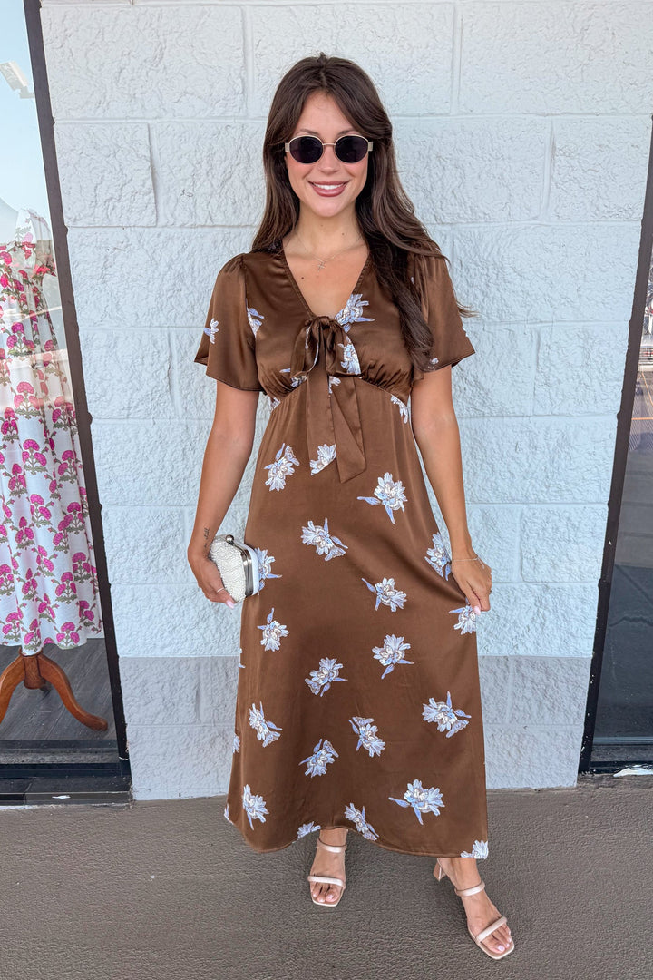 brown satin midi dress with light blue floral print and tie chest detail