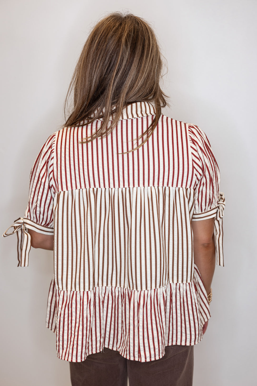 Women's cream tiered babydoll top with burgundy and brown colorblock stripes by Fantastic Fawn showing up close back view