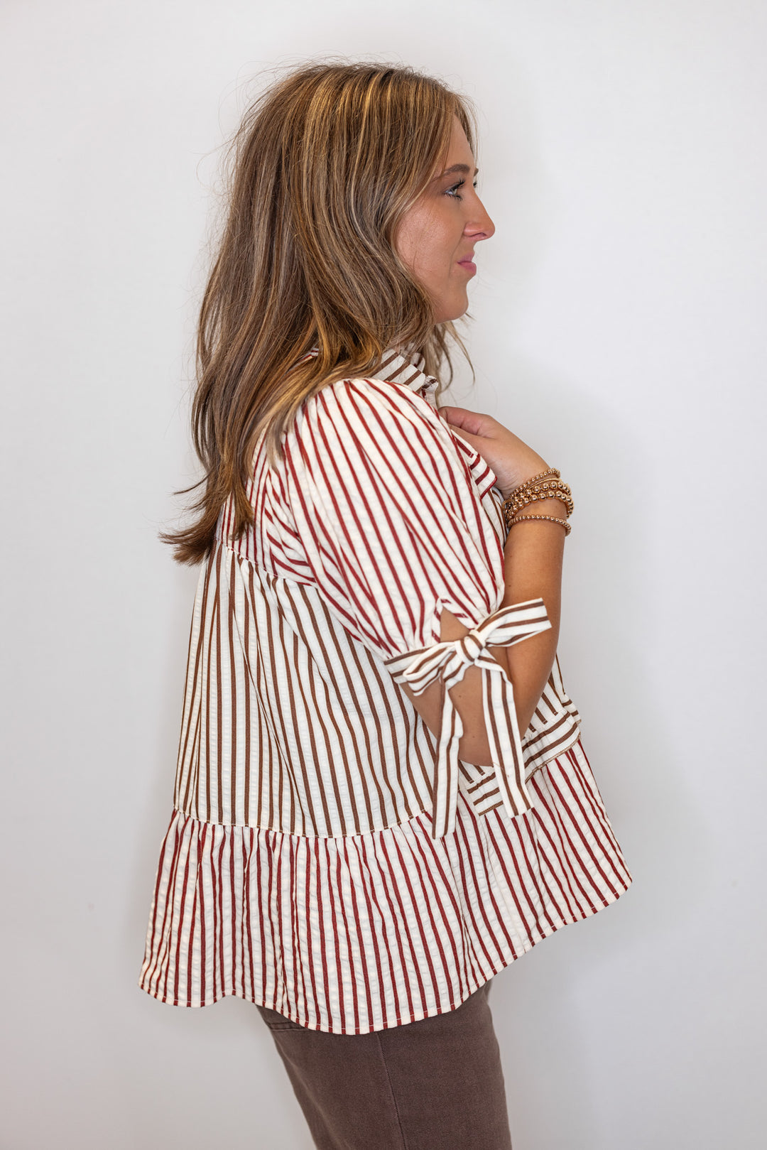 Women's cream tiered babydoll top with burgundy and brown colorblock stripes by Fantastic Fawn showing up close side view