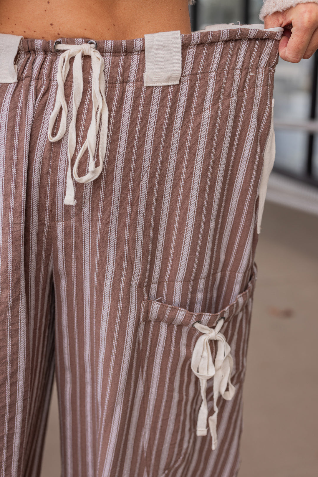 Women's milk chocolate brown linen cargo jogger pants with cream stripes by ee:some showing waistband stretch