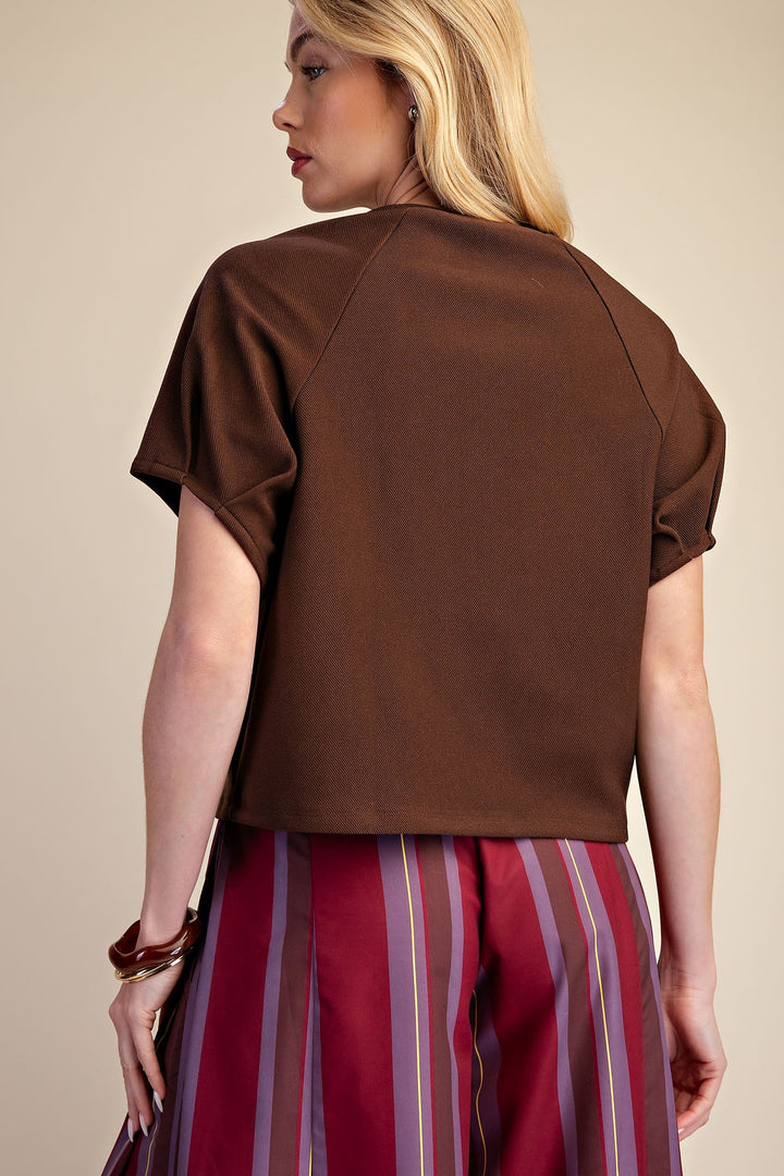 Brown knit top with gathered puff sleeves and a flattering silhouette