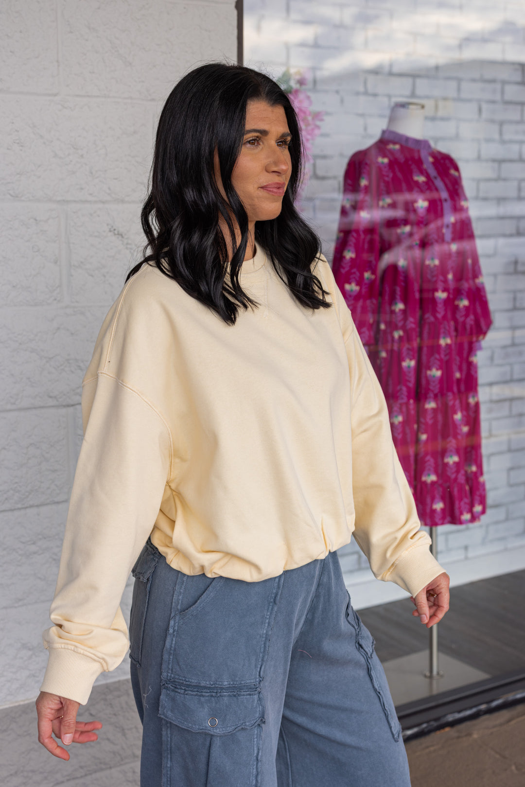 Women's butter pale yellow terry knit long sleeve pullover top with bubble hem by Wishlist showing up close side view