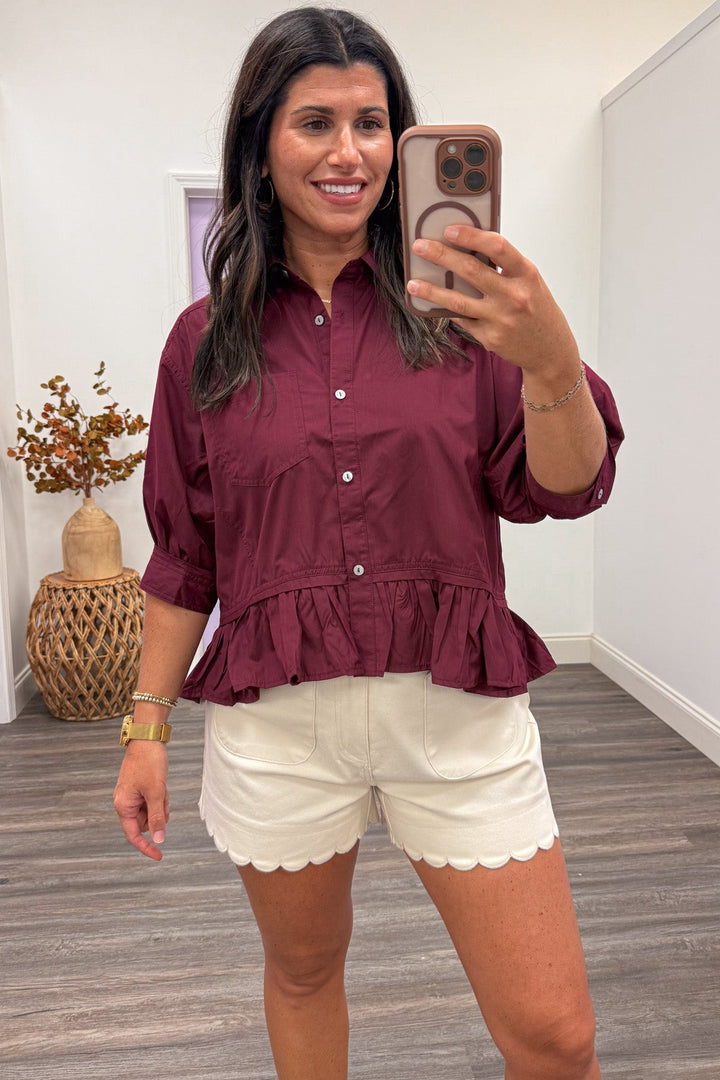 solid burgundy button front peplum style ruffle hem semi-cropped top