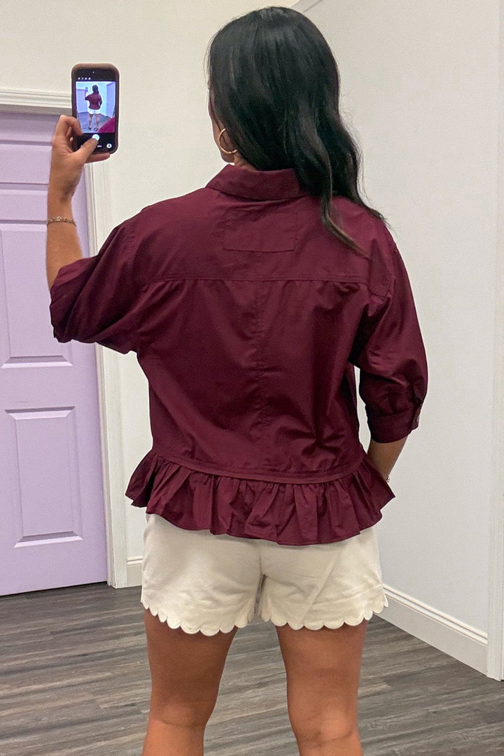 solid burgundy collared neckline button front peplum style ruffle hem semi-cropped top