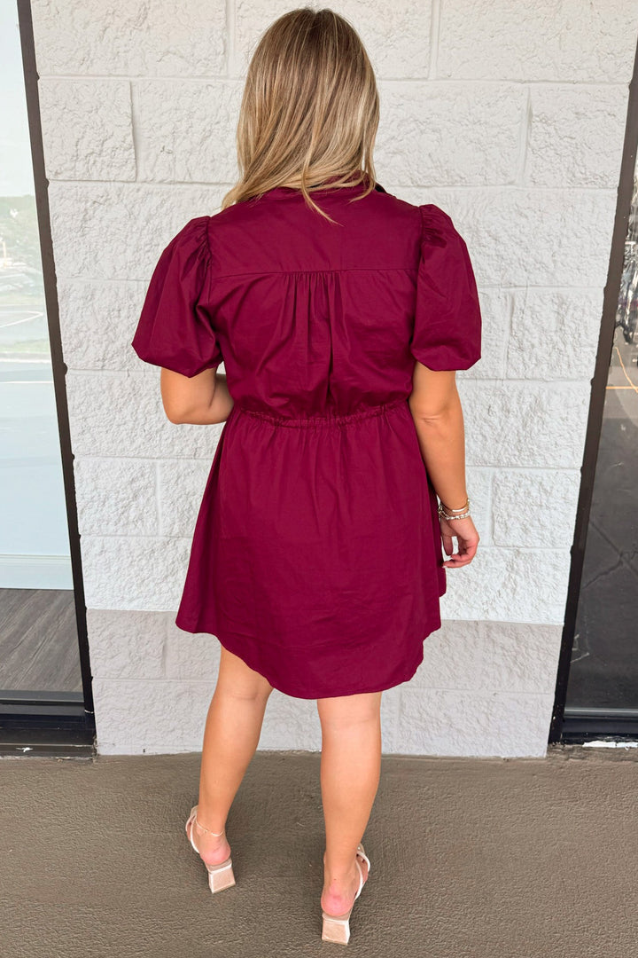 solid burgundy flap covered button front puff sleeve cinch waist cotton poplin short dress