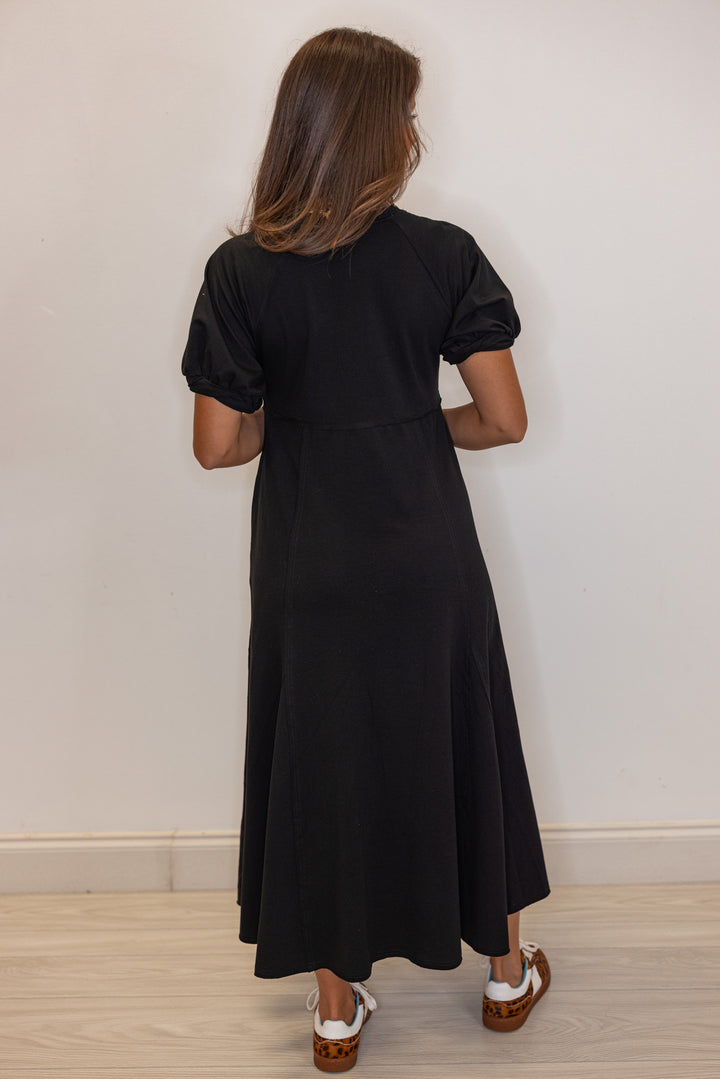 Black terry knit puff sleeve midi dress with raw seam details by Jodifl showing full back view