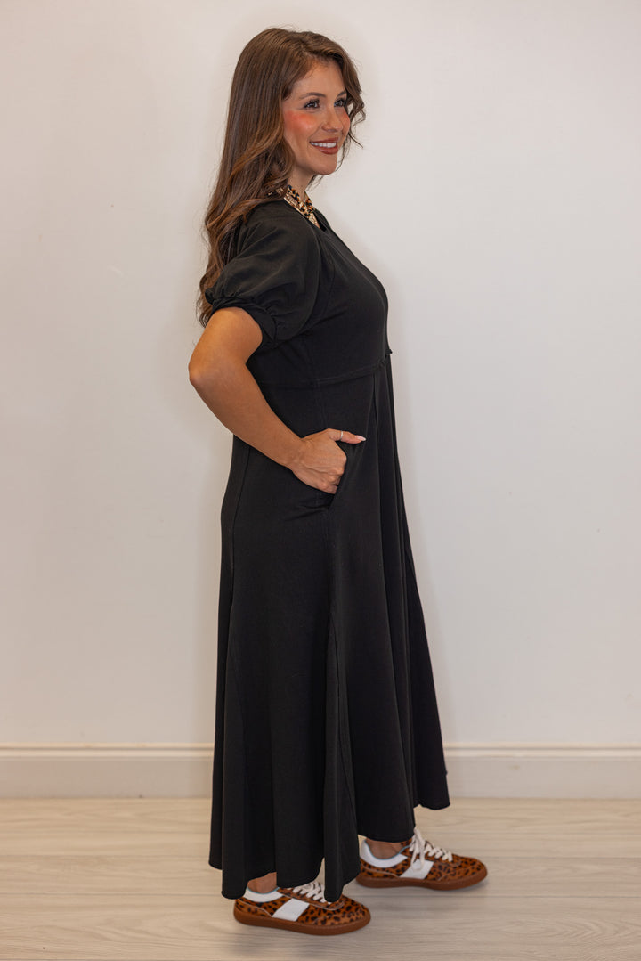 Black terry knit puff sleeve midi dress with raw seam details by Jodifl showing full side view
