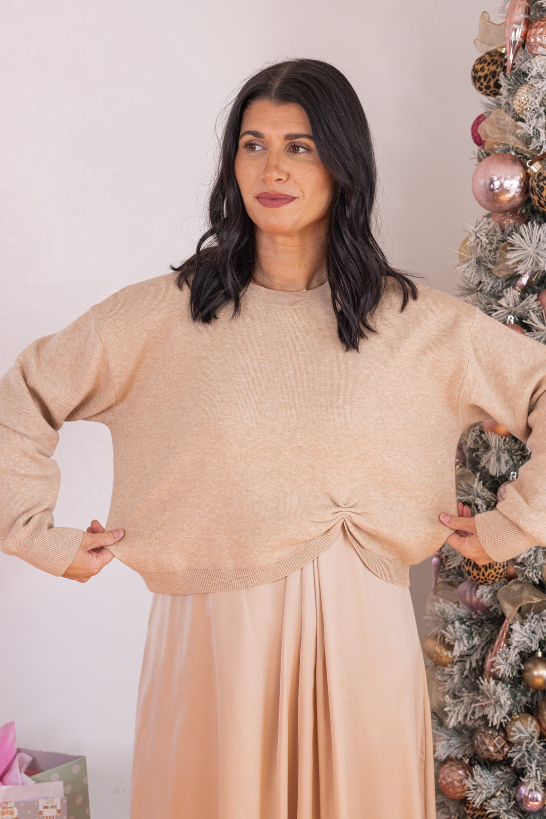 Women's champagne knit cropped sweater top with knotted detail at the hem by Jodifl showing true to size fit