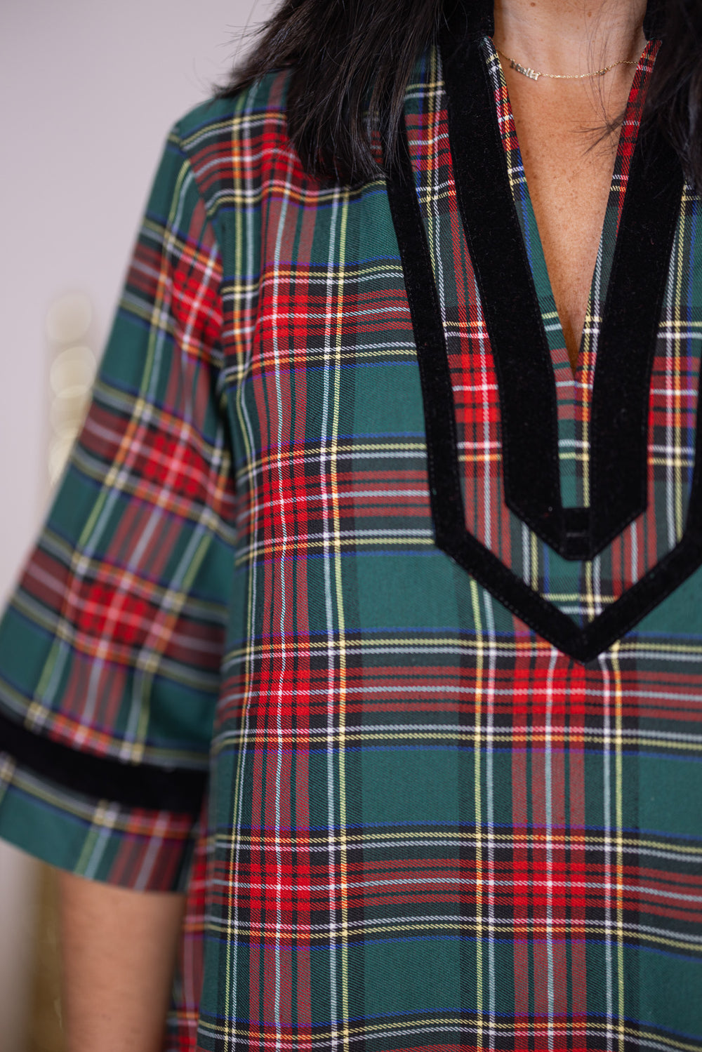 Women's green and red plaid dress with black velvet trim by Entro showing bodice view