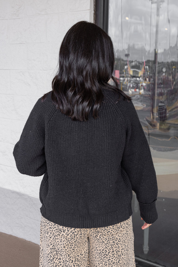 Women's black open front ribbed knit sweater cardigan by Entro showing up close back view