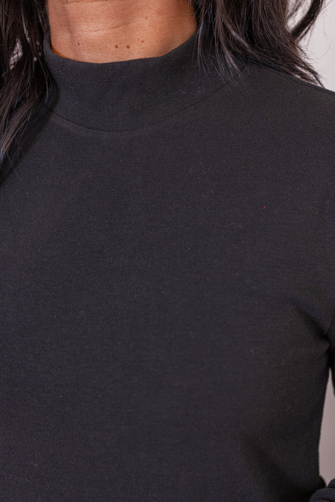 Women's black knit long sleeve top by Jodifl showing mock neckline