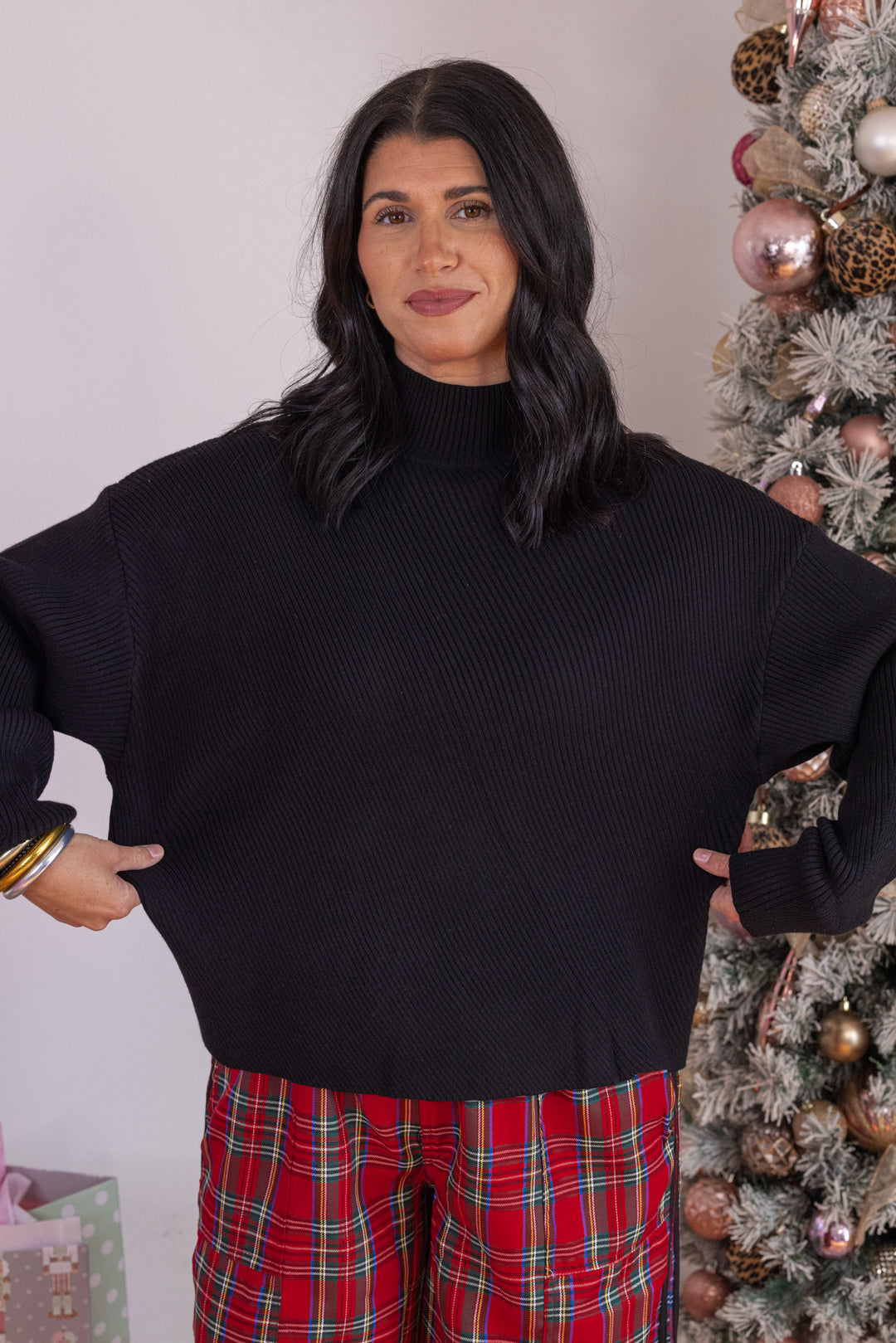 Women's black diagonal ribbed knit sweater top by Hyfve showing true to size fit