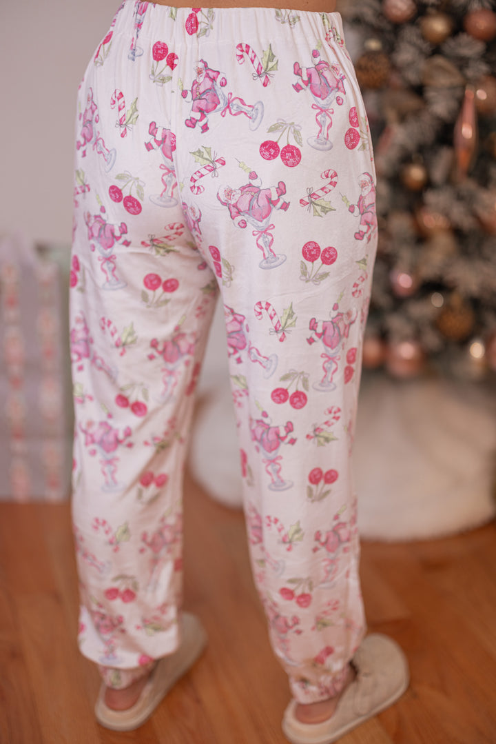 Women's white pajama lounge jogger pants with pink cherry santa print by Peach Love California showing up close back view