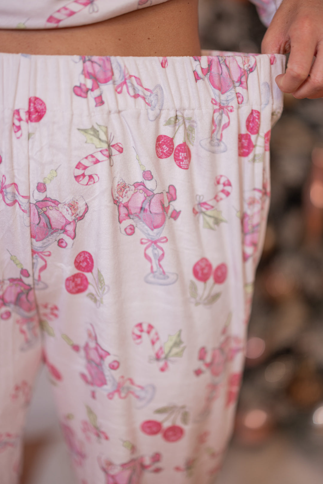 Women's white pajama lounge jogger pants with pink cherry santa print by Peach Love California showing elastic waistband