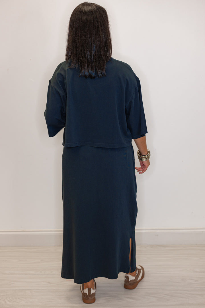 Back view of Women's navy knit maxi skirt and short sleeve top set