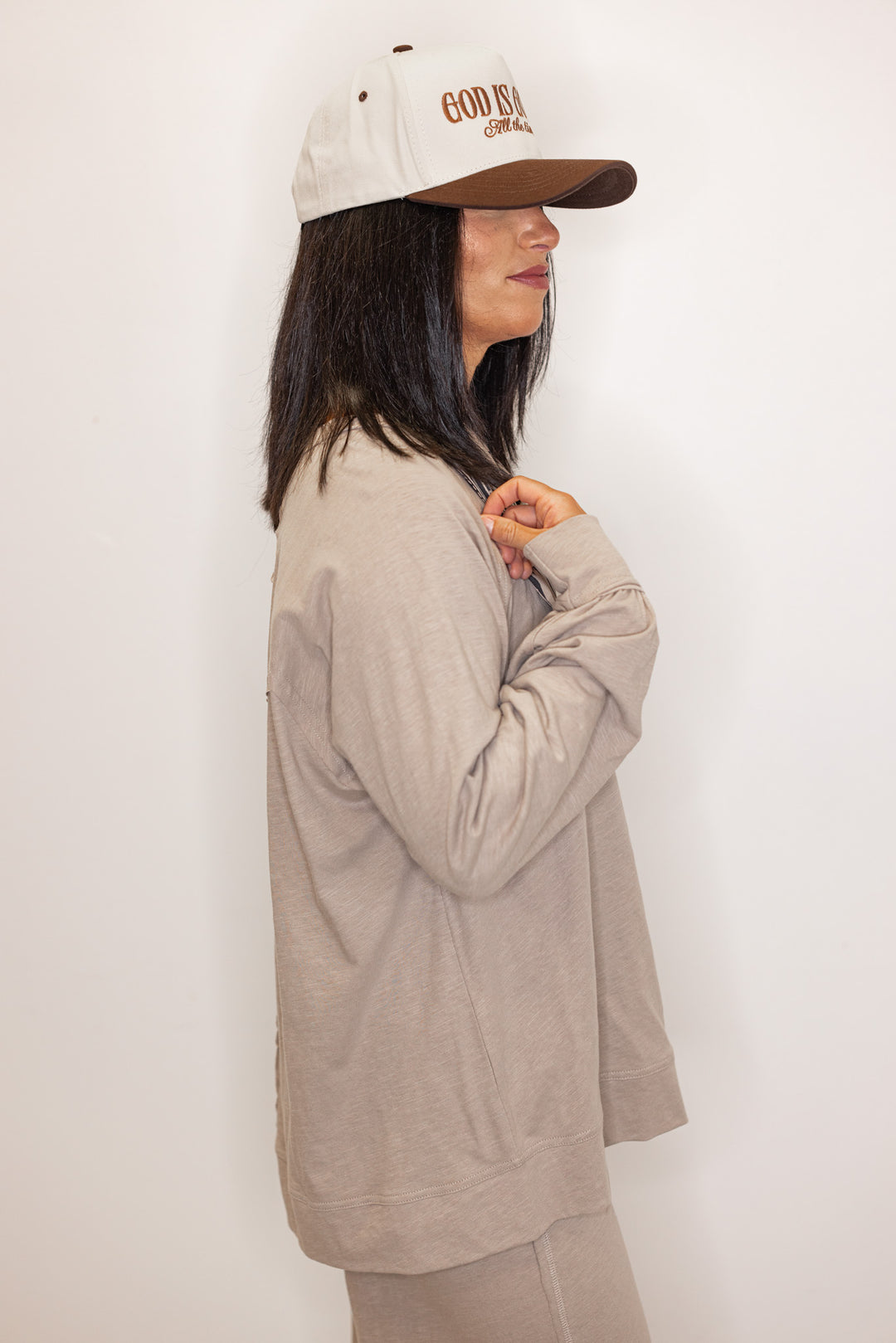Side view of Women's beige long sleeve crew neck tee