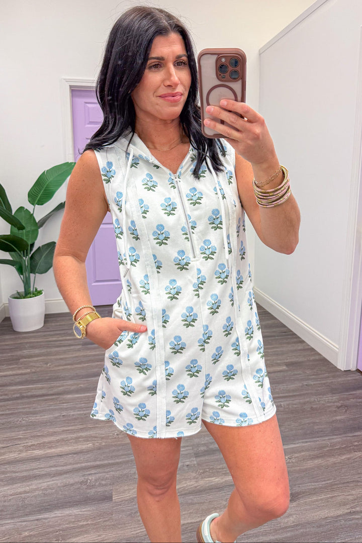 white with blue floral print quarter zip sleeveless terry knit romper