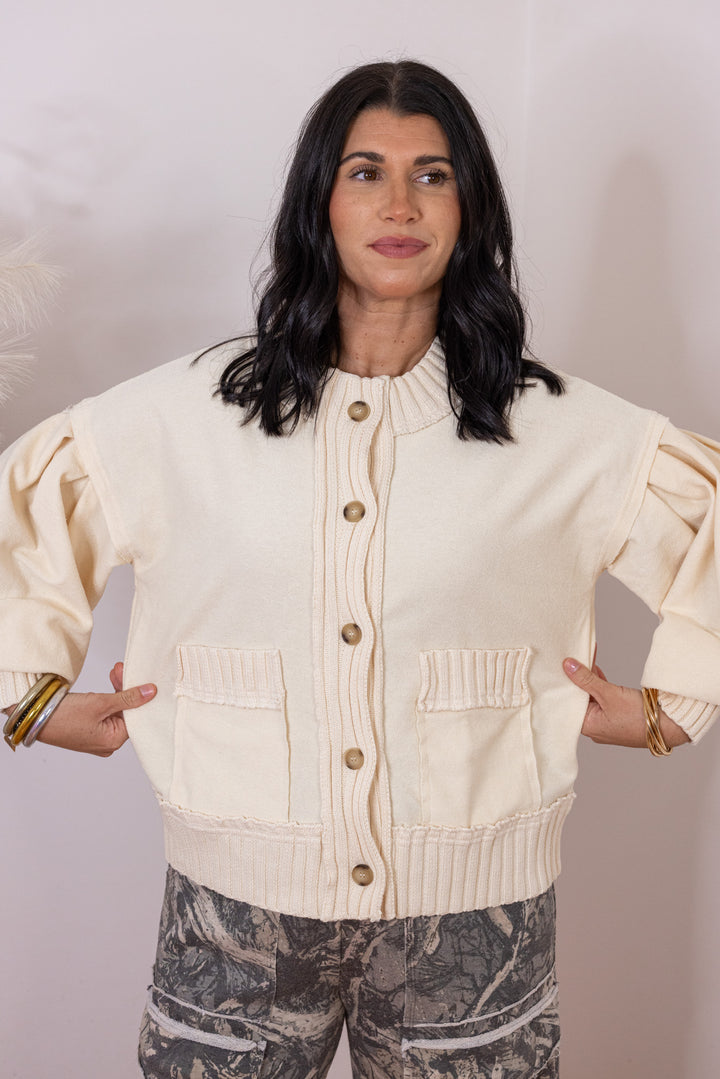 Women's ecru terry knit button front cardigan with textured ribbed knit trim by Entro showing true to size fit