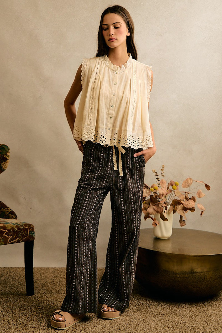 Cream button front top with embroidery floral lace details in a sleeveless style