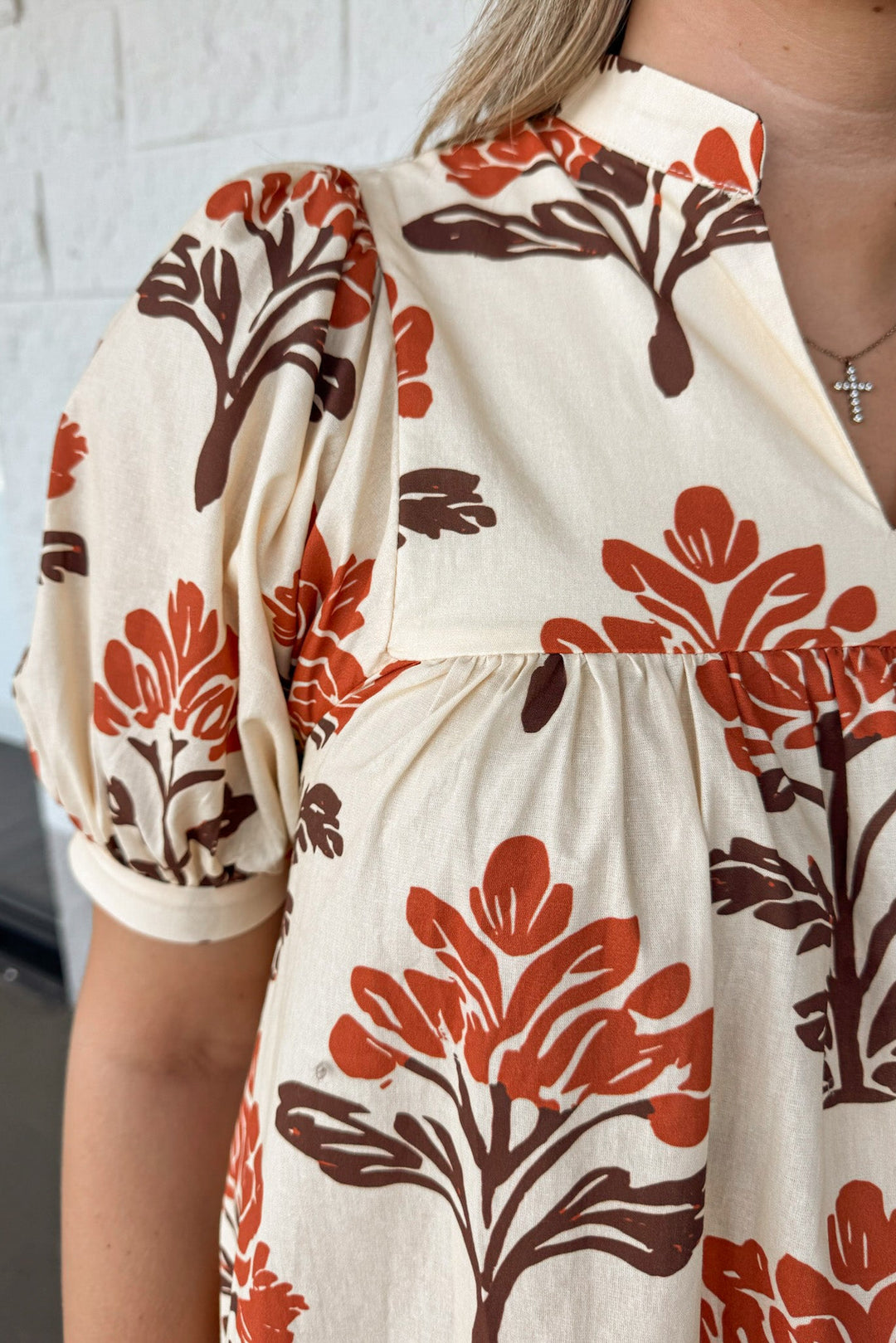cream with orange and brown floral print puff sleeve v neckline poplin midi dress