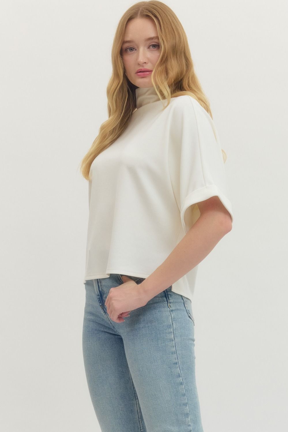 Women's cream scuba knit top with mock neck and dolman sleeves by Enrto showing side view and sleeve