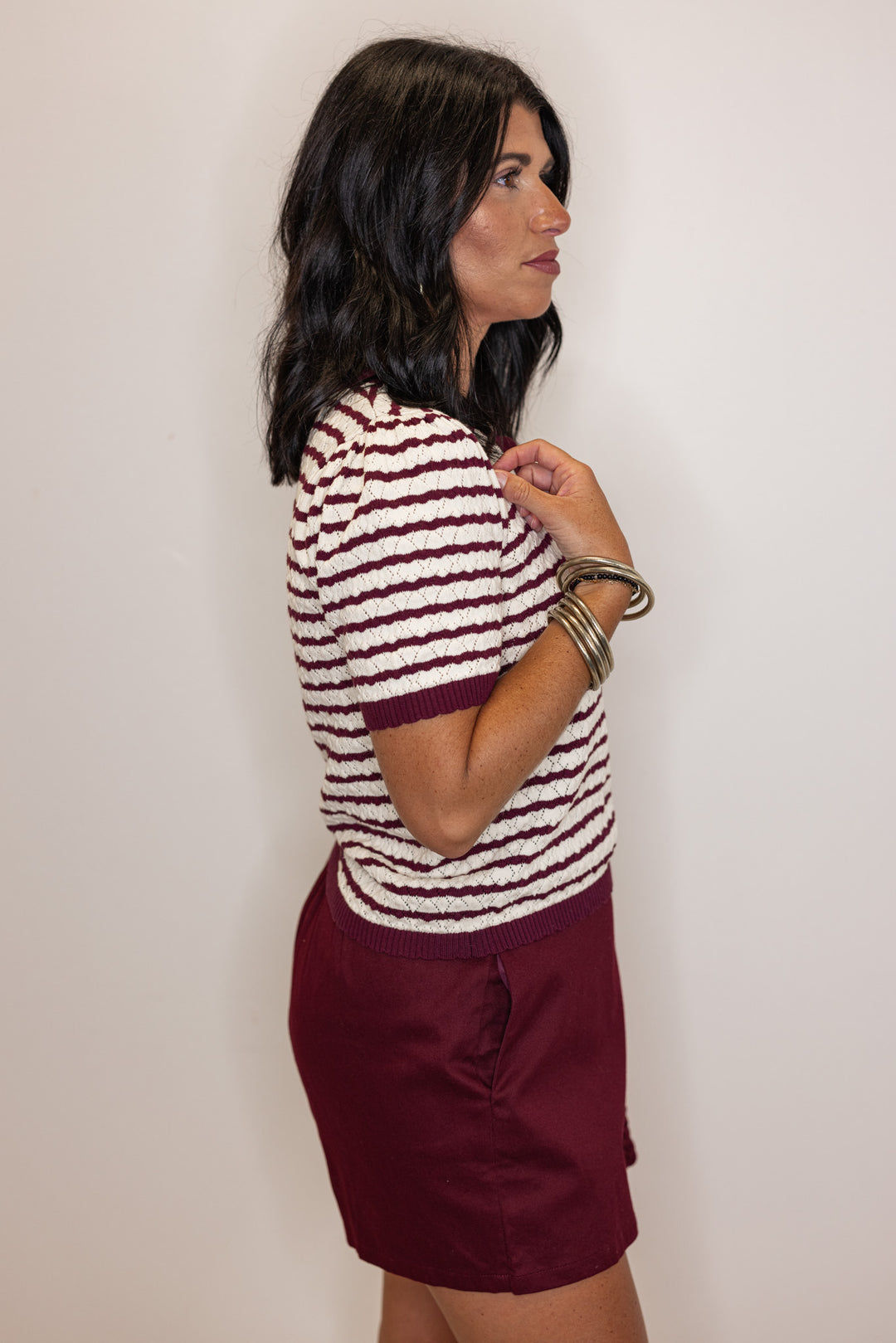 Women's burgundy and cream striped knit top with scalloped trim by Entro showing up close side view