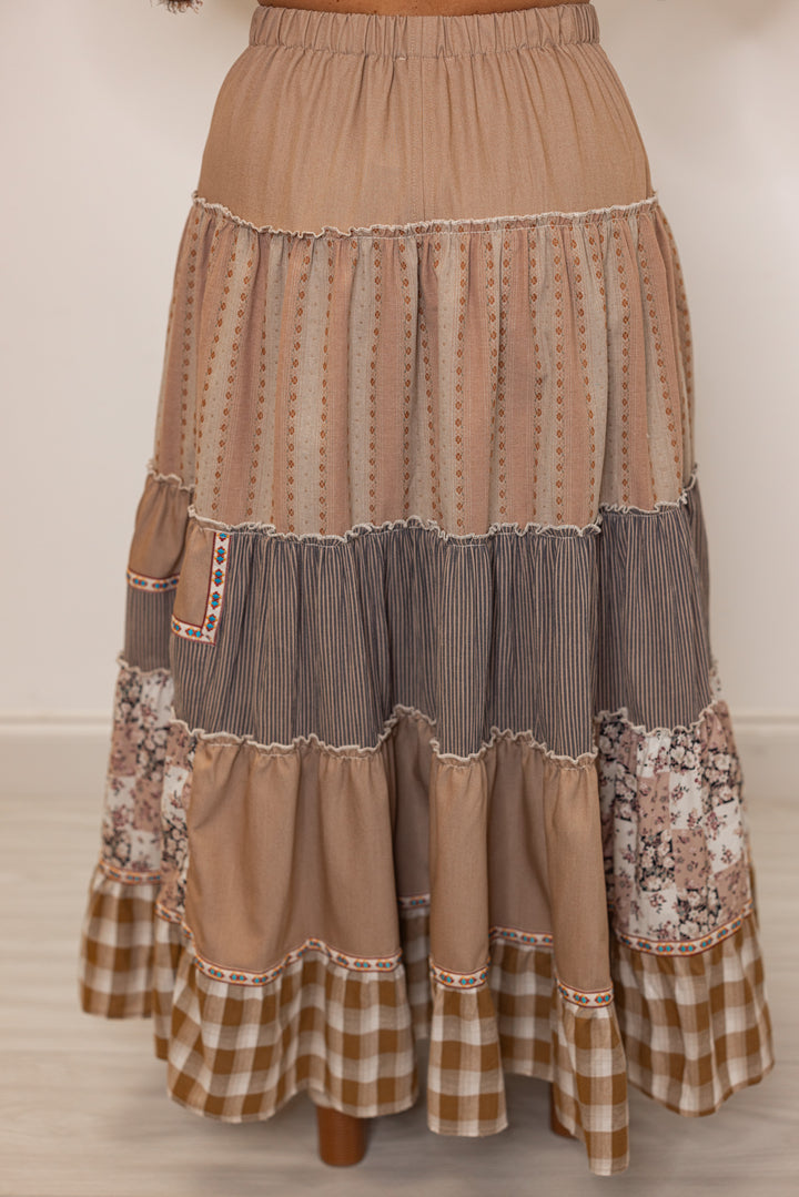 Back side of women's brown layered patterned boho maxi skirt with elastic waistband