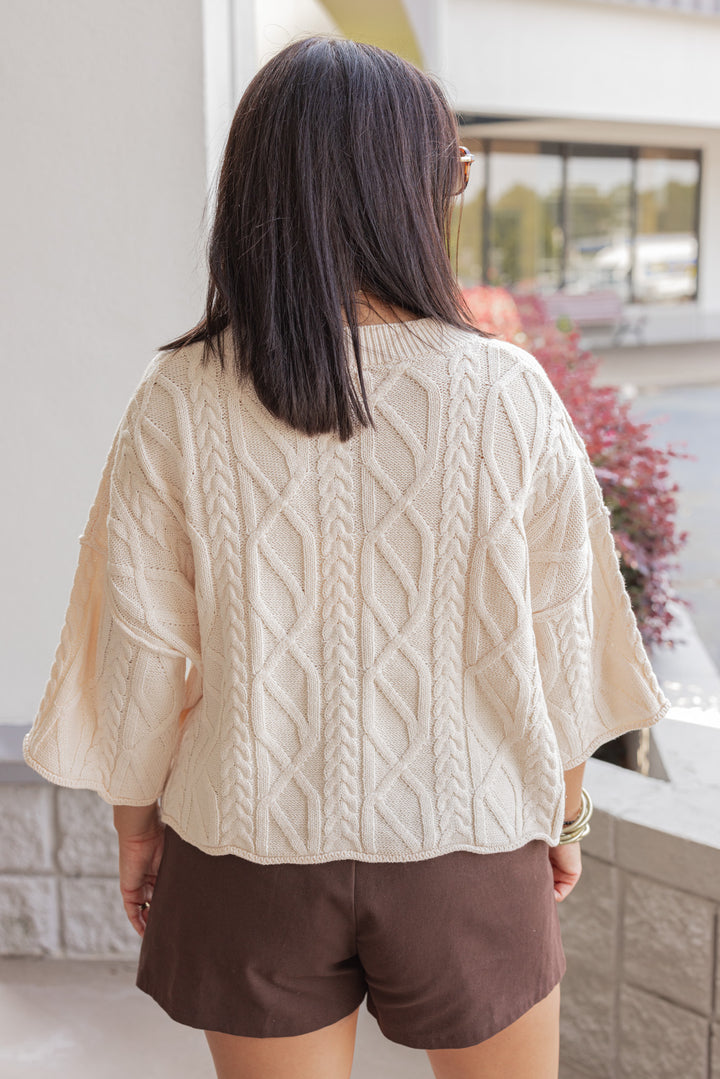 Women's ecru cable knit cropped sweater by Entro showing up close back view