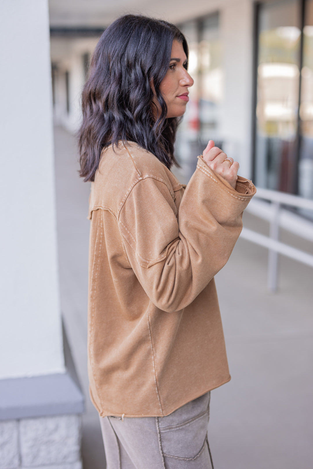 Women's mineral washed caramel terry knit pullover with raw/reverse seam details by Easel showing up close side view