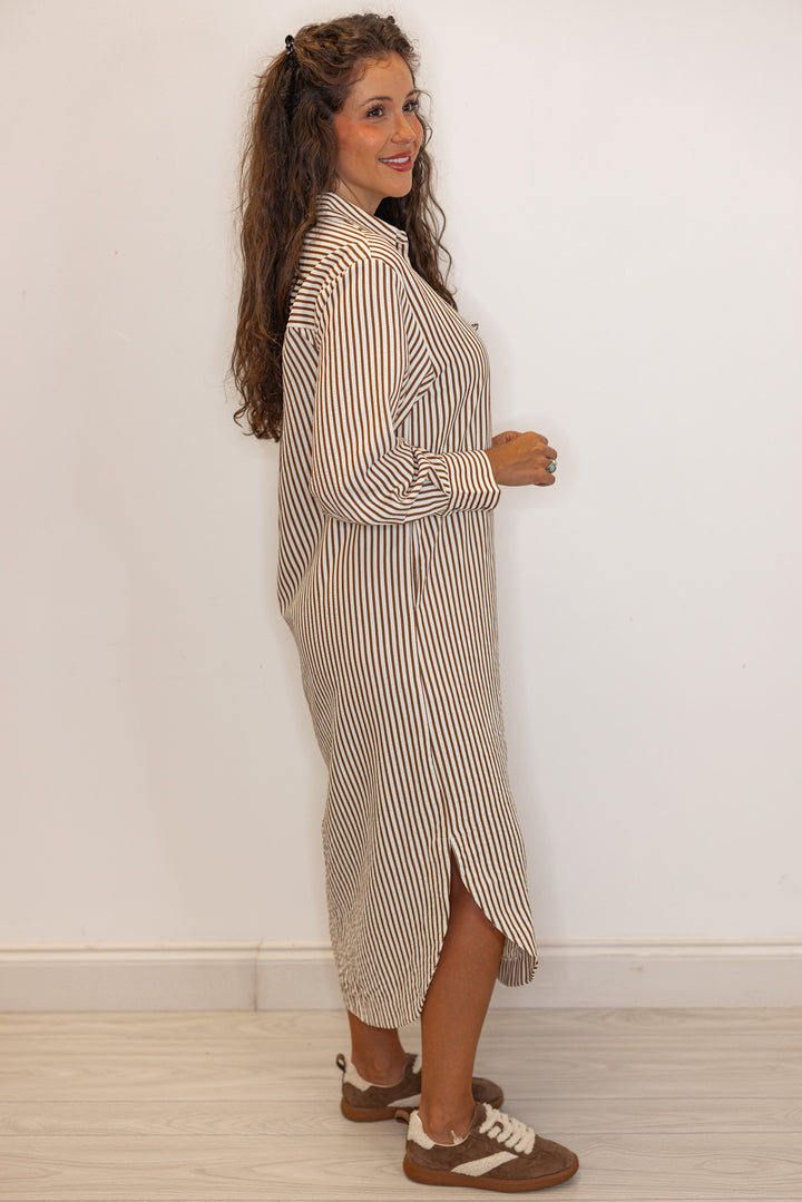 Side view of Women's long sleeve caramel and ivory  striped maxi dress