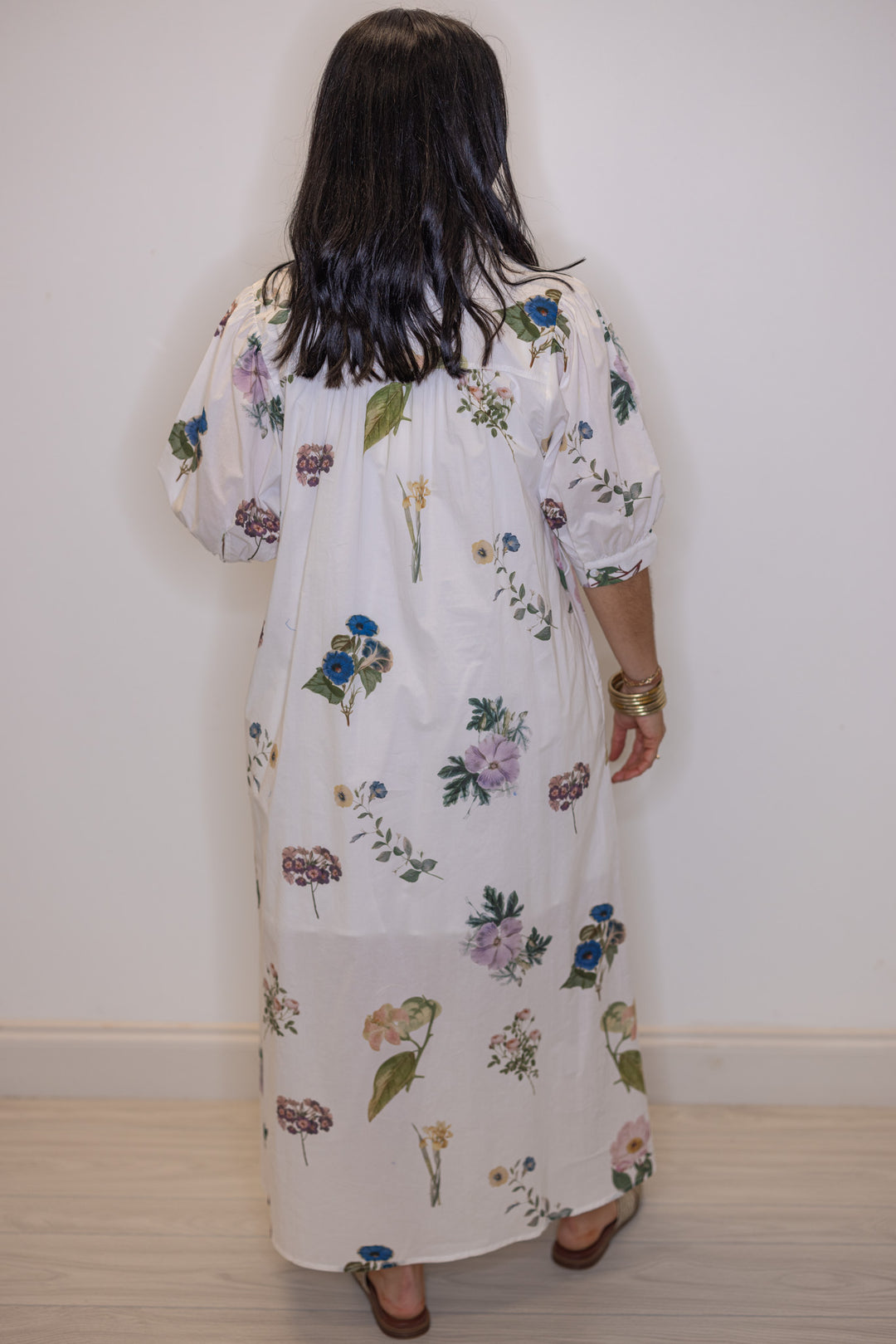 Women's off white floral print button front midi dress with belted waist by Entro showing pleated details in the back