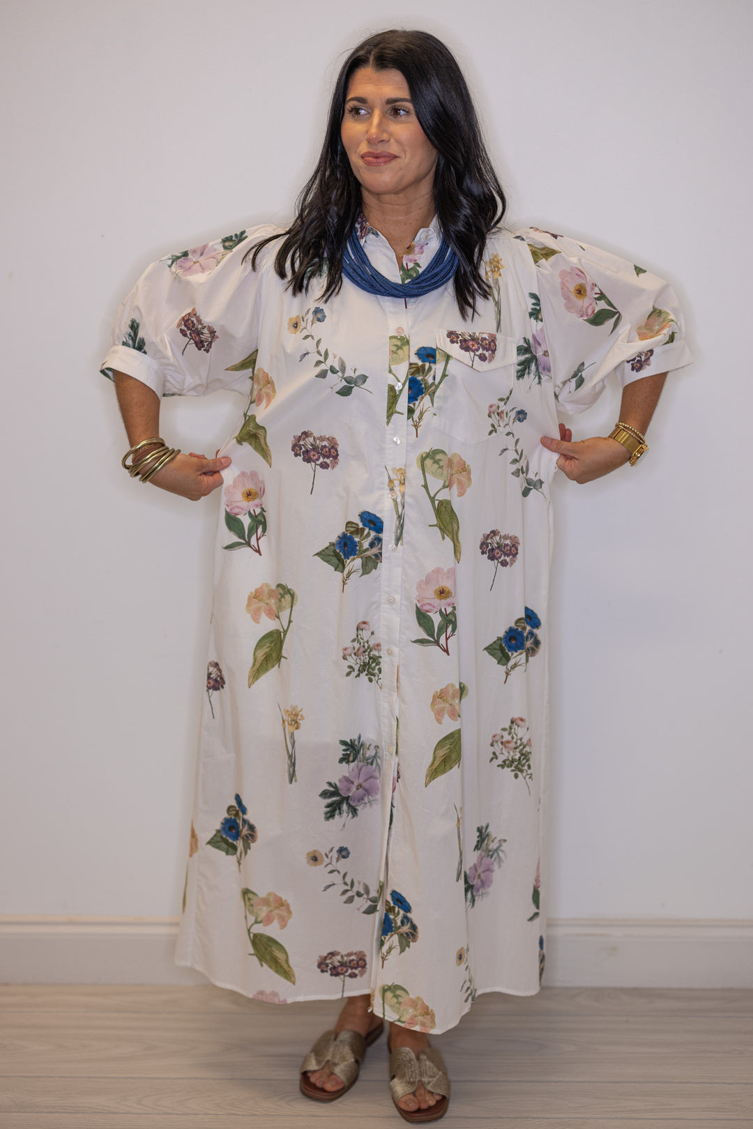 Women's off white floral print button front midi dress with belted waist by Entro shoiwng true to size fit