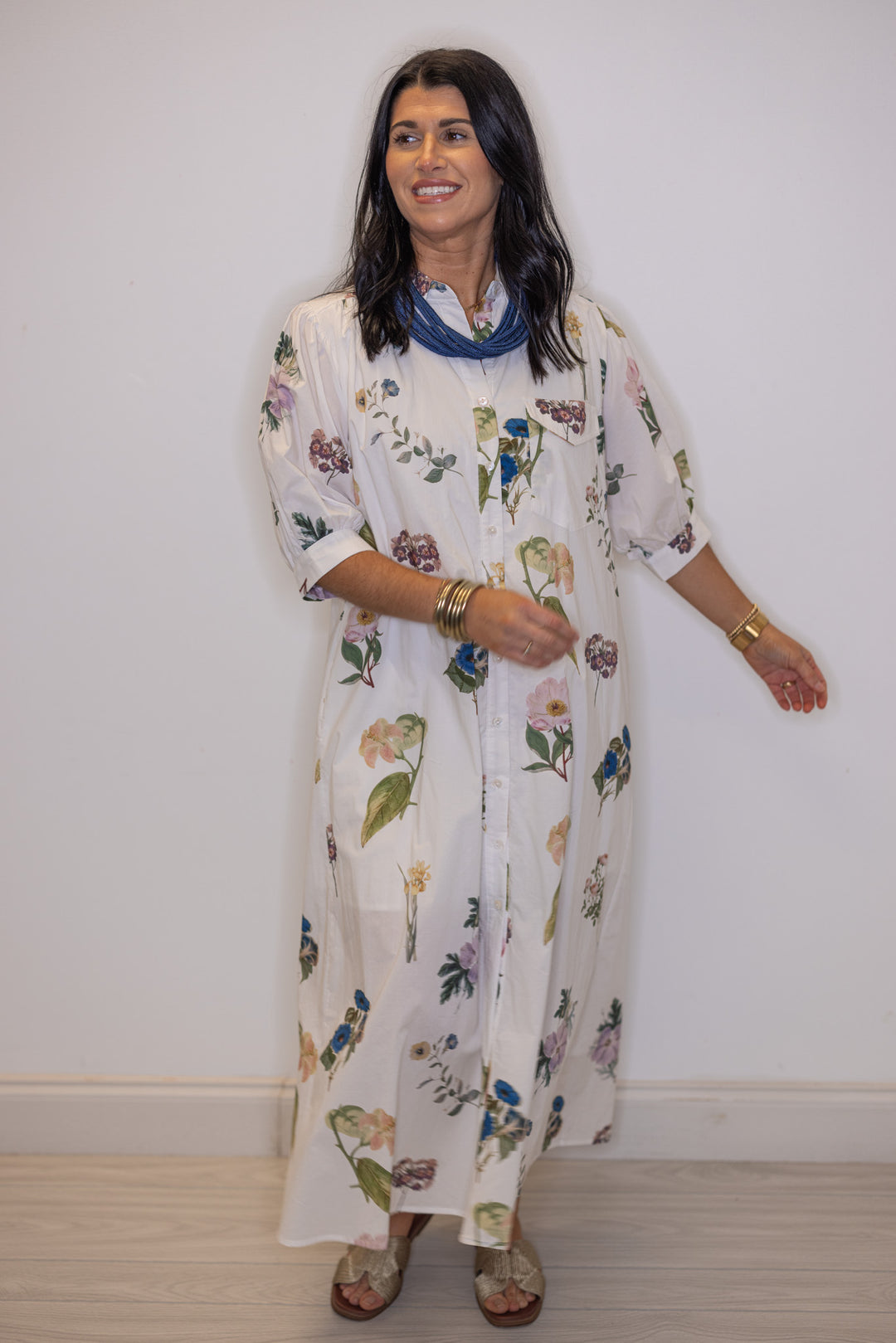 Women's trendy off white floral print dress with belted waist by Entro showing midi length 