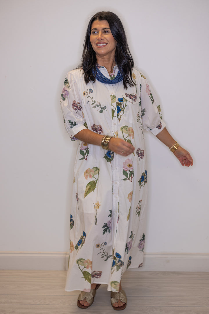 Women's trendy off white floral print dress with belted waist by Entro showing midi length 