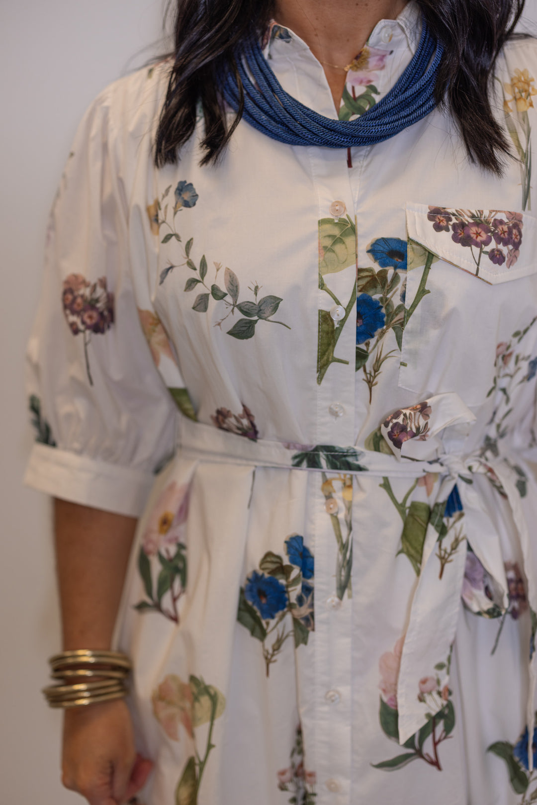 Women's off white floral print midi dress by Entro showing belted waist