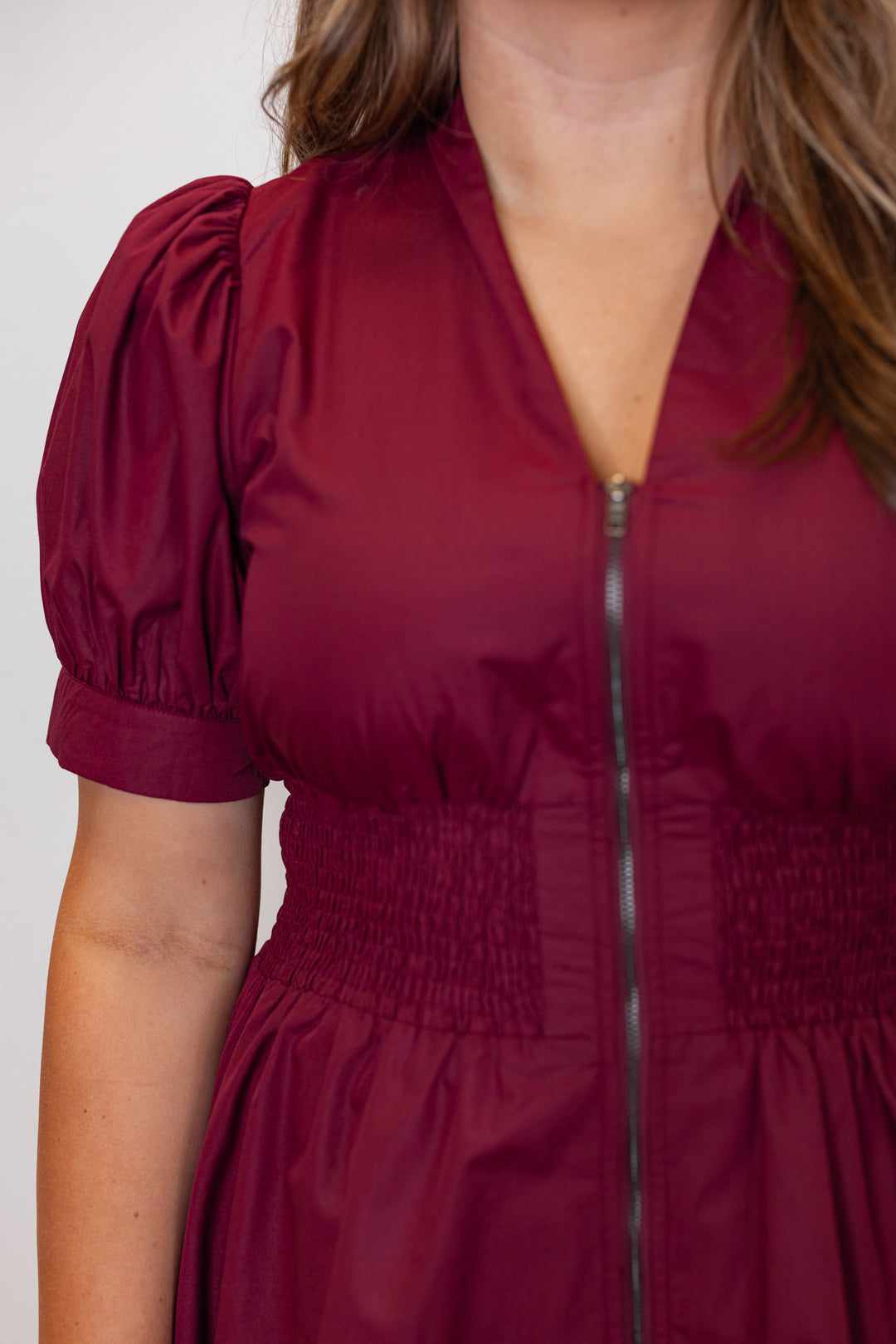 Women's zip front smocked waist burgundy dress by Entro showing elastic smocked waistband