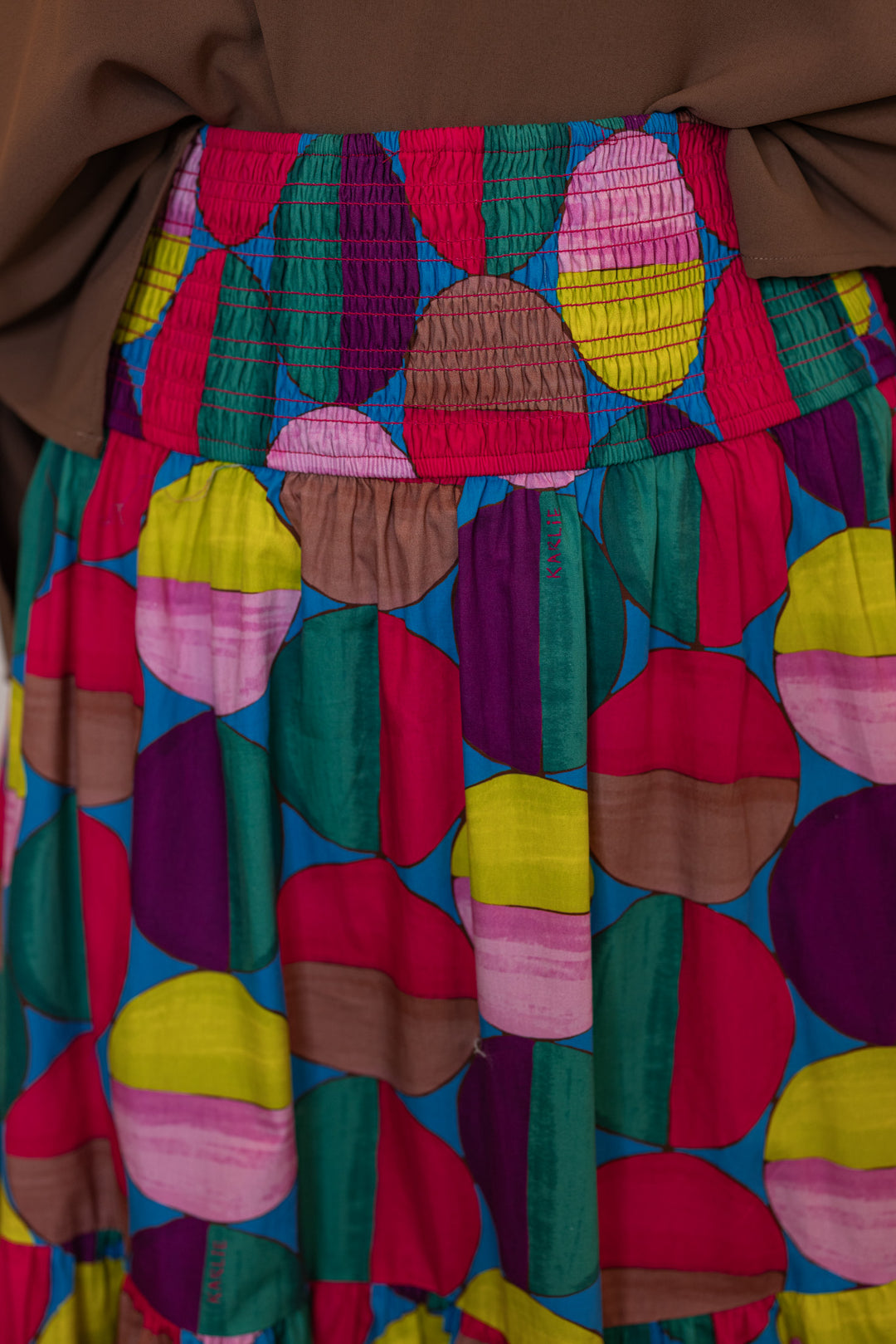 Women's smocked hot pink and multicolor print tiered poplin maxi skirt by Karlie showing smocked waistband